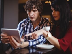 Man and a woman looking at a cel phone Man and a woman looking at a cel phone