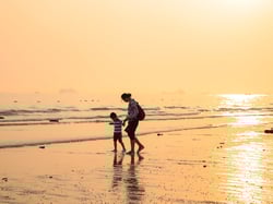 Woman and her child on a beach Woman and her child on a beach