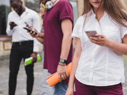Students checking cel phones Students checking cel phones